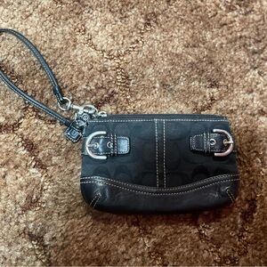 Black Coach wristlet with silver hardware. Single pocket.